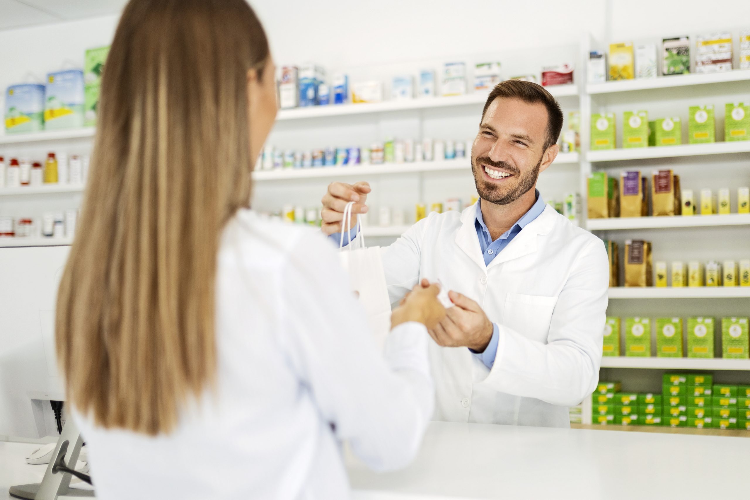 Pharmacist Handing Medication to Patient